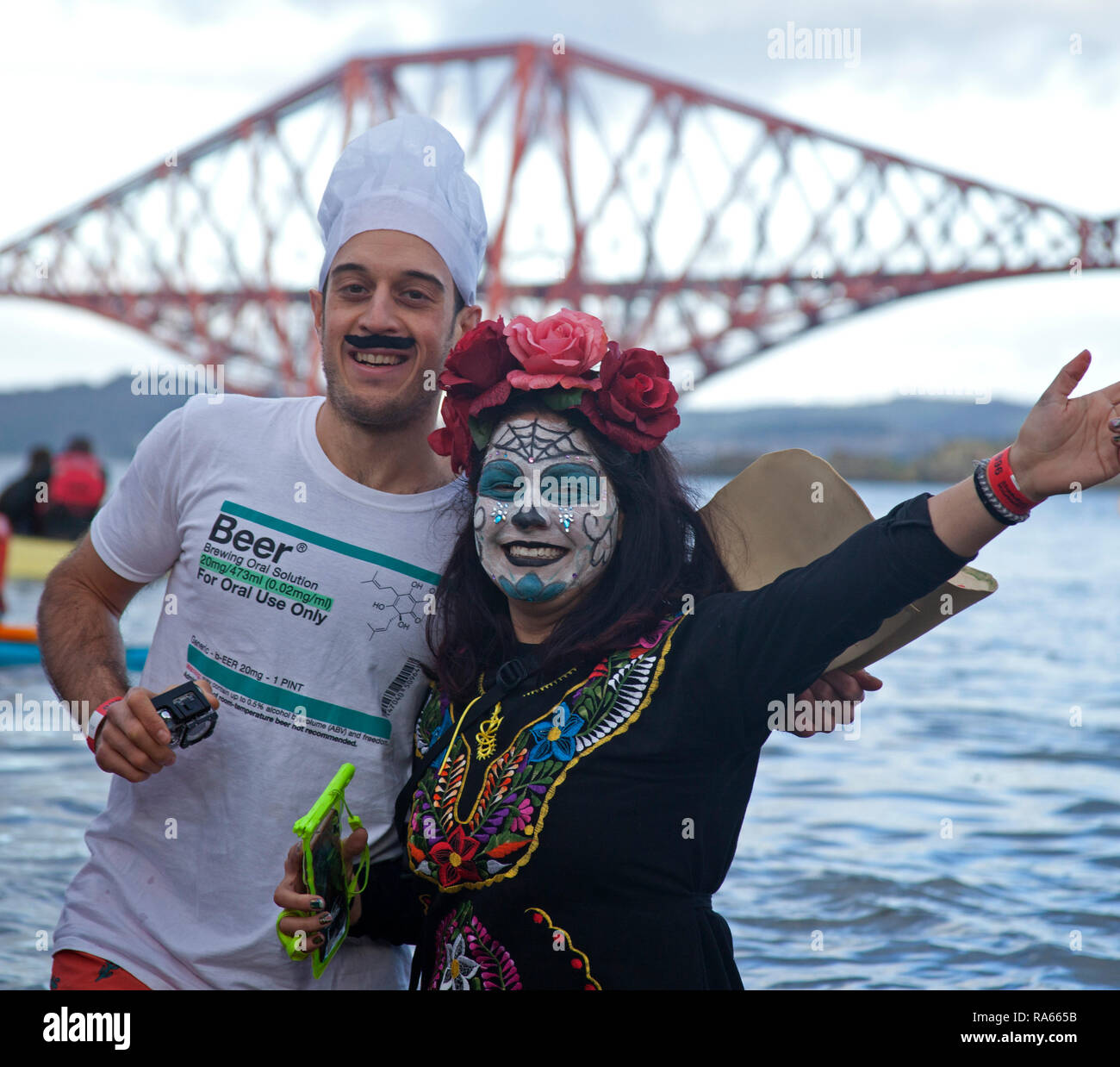 South Queensferry, Edinburgh, Scotland UK. 01 January 2019. Queensferry New Year Loony Dook, the annual dip in the Firth of Forth in the shadow of the world-famous Forth Rail Bridge. Takes place on the third day of the Edinburgh Hogmany New Year celebrations. Maximum capacity crowd Stock Photo