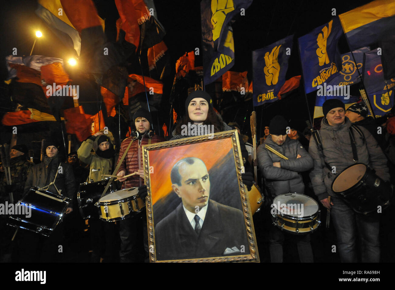 Kiev, Ukraine. 1st Jan, 2019. An Activist of the Ukrainian nationalist parties seen holding a portrait of Stepan Bandera, founder of a Ukrainian Insurgent Army during a rally on the occasion of 110th birth anniversary. In 1959 Stepan Bandera was killed by a KGB agent Bogdan Stashinsky in Germany. Credit: Sergei Chuzavkov/SOPA Images/ZUMA Wire/Alamy Live News Stock Photo