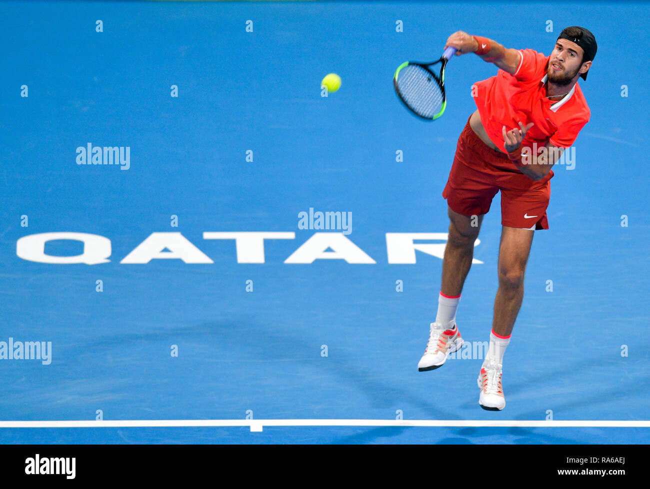 Doha, Qatar. 1st Jan, 2019. Karen Khachanov of Russia serves during the  singles first round match against Stan Wawrinka of Switzerland at the ATP  Qatar Open Tennis match in Doha, capital of