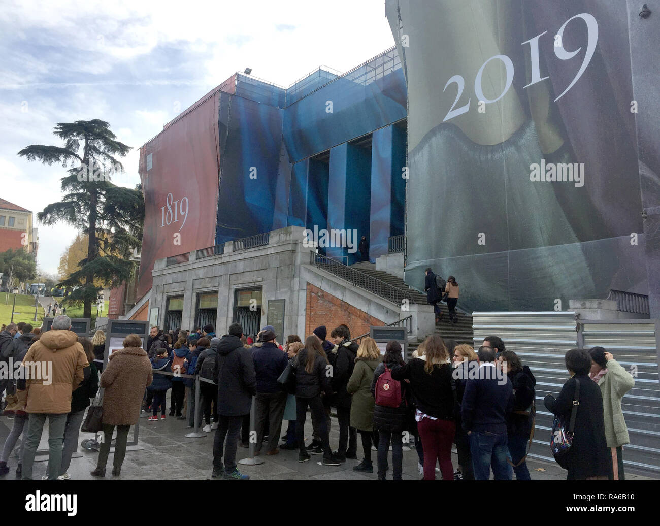 Madrid, Spain. 08th Dec, 2018. A queue of visitors in front of the Prado, on the front of which the dates of the anniversary are displayed: 1819 - 2019. The museum is a must during a visit to Madrid. The Prado is Spain's art temple par excellence. The museum celebrates its 200th anniversary in 2019. (to dpa 'Where the crème de la crème of art cavorts: The Prado will be 200' from 02.01.2018) Credit: Carola Frentzen/dpa/Alamy Live News Stock Photo