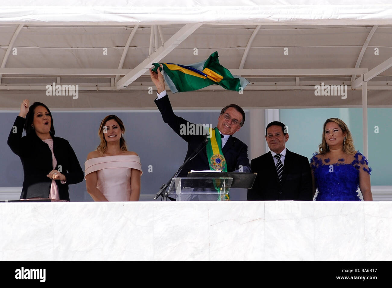 Brasilia, Brazil. 01st Jan, 2019. Brazil's new president Jair Bolsonaro (M) waves to the crowd from the Planalto presidential palace. Next to him are his wife Michelle Bolsonaro (2nd from left), Vice President Hamilton Mourao (2nd from right) and his wife Paula Mourao (right). The ultra-right ex-military Jair Bolsonaro has been sworn in as the new president of Brazil. The 63-year-old took his oath of office in Congress on Tuesday. Credit: Alan Morici/dpa/Alamy Live News Stock Photo