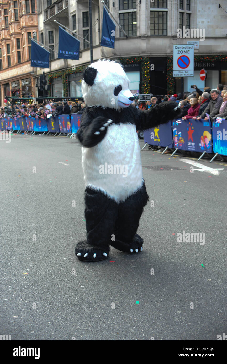 A performer wearing a panda suit takes part in a parade during London's ...