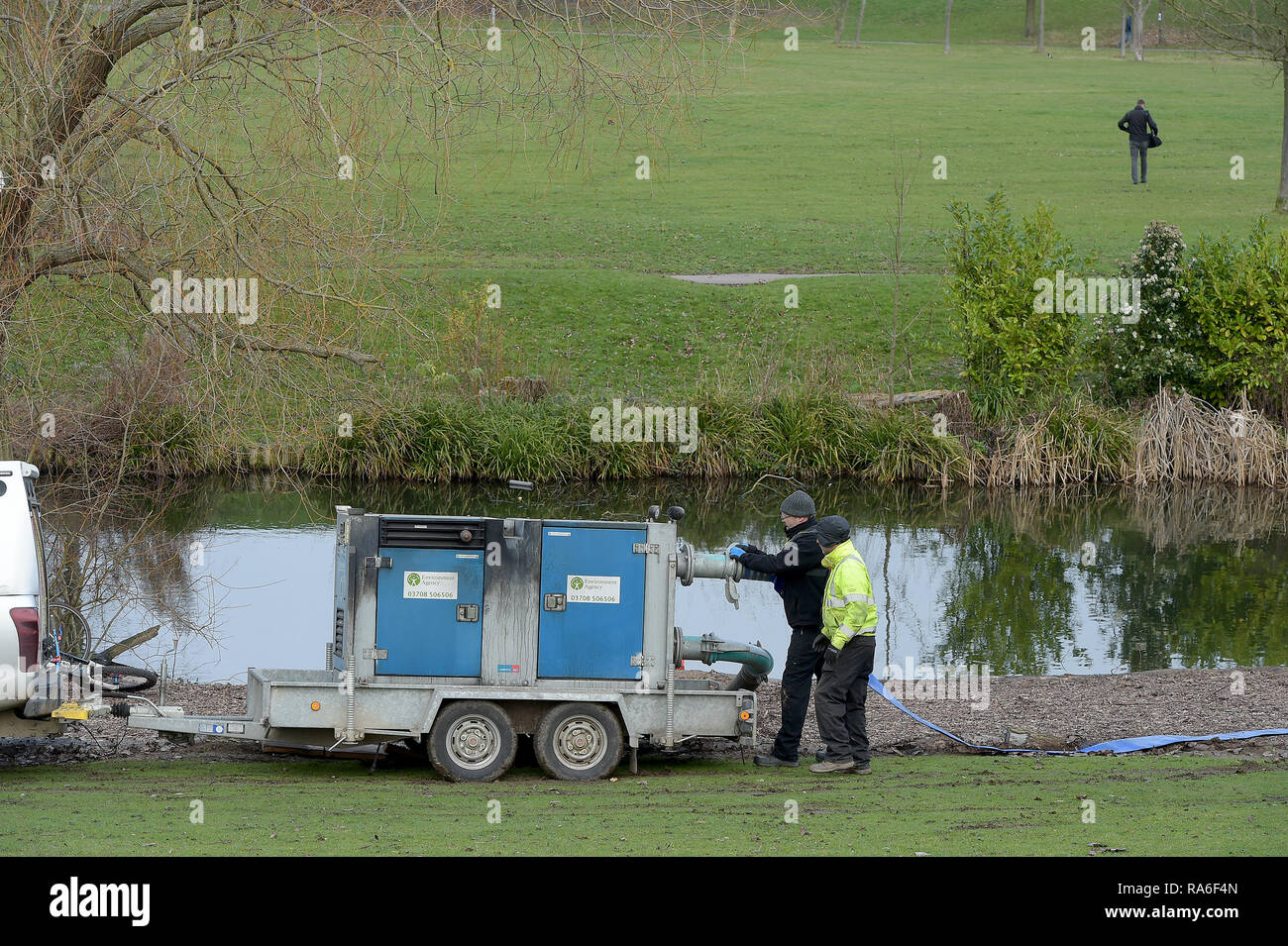 Basildon, Essex, UK. 2nd Jan 2019. Essex Police officers along with the Environmental Agency drain the fishing lake in Gloucester Park Basildon Essex in the search for a missing 28 year old man. Jack Morrad was last seen at 2:30am on CCTV on Sunday December 23 in nearby Blake Avenue. Throughout the festive period Police officers and Jack's family and friends have carried out searches of the park and surrounding waterways. Following the conclusion of these searches it was decided to completely drain the main fishing lake. Credit: MARTIN DALTON/Alamy Live News Stock Photo
