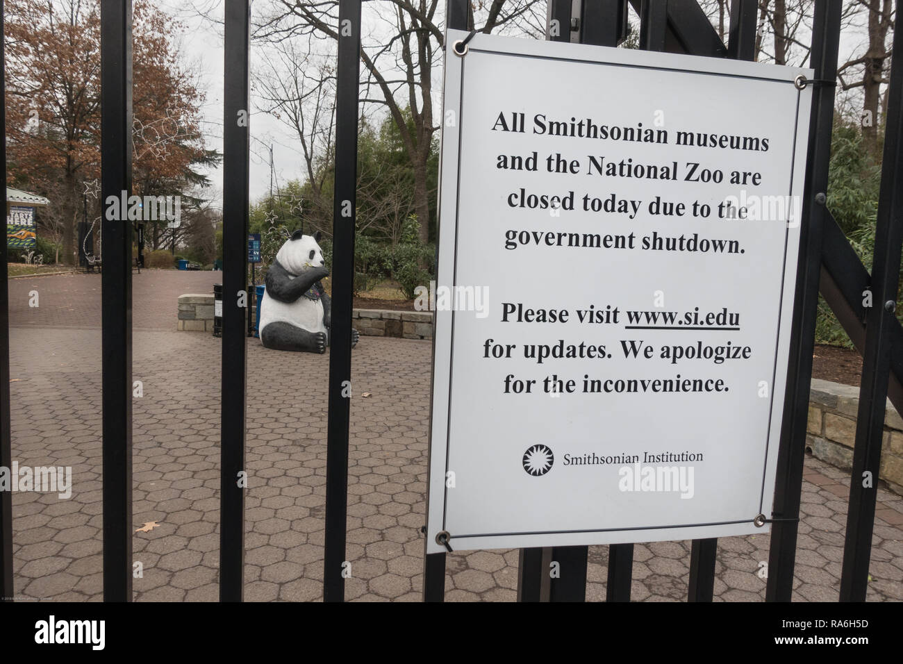 Washington, DC, USA.  2nd January, 2019. Sign at the National Zoo alerting would-be visitors, that the zoo and all Smithsonian Museums are closed because of the government shutdown.  The zoo and museums had been open during the partial shutdown, which began Dec. 22, but funding ran out Jan. 2. Lonely panda sculpture sits behind closed gates. Bob Korn/Alamy Live News Stock Photo