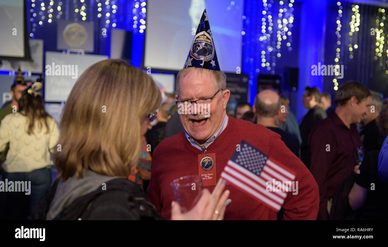 Employees and guests celebrate at the moment the New Horizons spacecraft successfully reach the closest approach to Kuiper Belt object Ultima Thule viewed from tat Johns Hopkins University Applied Physics Laboratory January 1, 2019 in Laurel, Maryland. Stock Photo