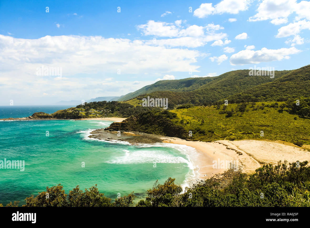 View onto Era Beach with clear blue and azure water and blue cloudy sky in summer in Royal National Park near Sydney (Sydney, Australia) Stock Photo