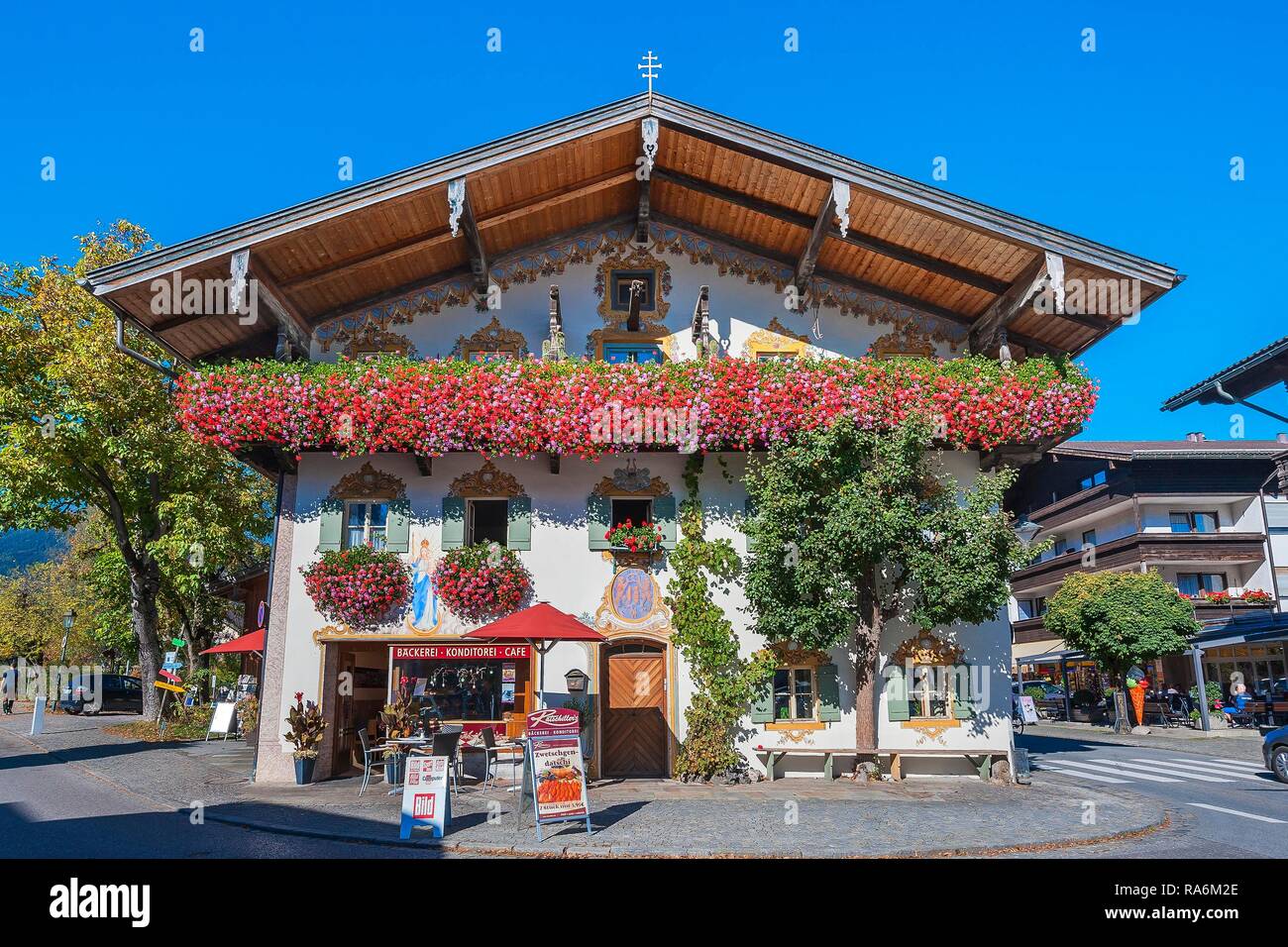 Flower decoration at the entrance of a confectionery café in Oberaudorf, Upper Bavaria, Bavaria, Germany Stock Photo