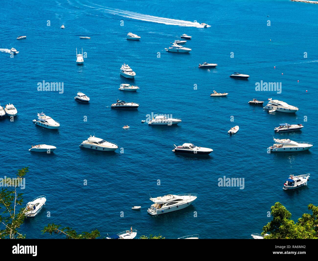 Motorboats anchor in the bay of Lacco Ameno, Island of Ischia, Gulf of Naples, Campania, Italy Stock Photo