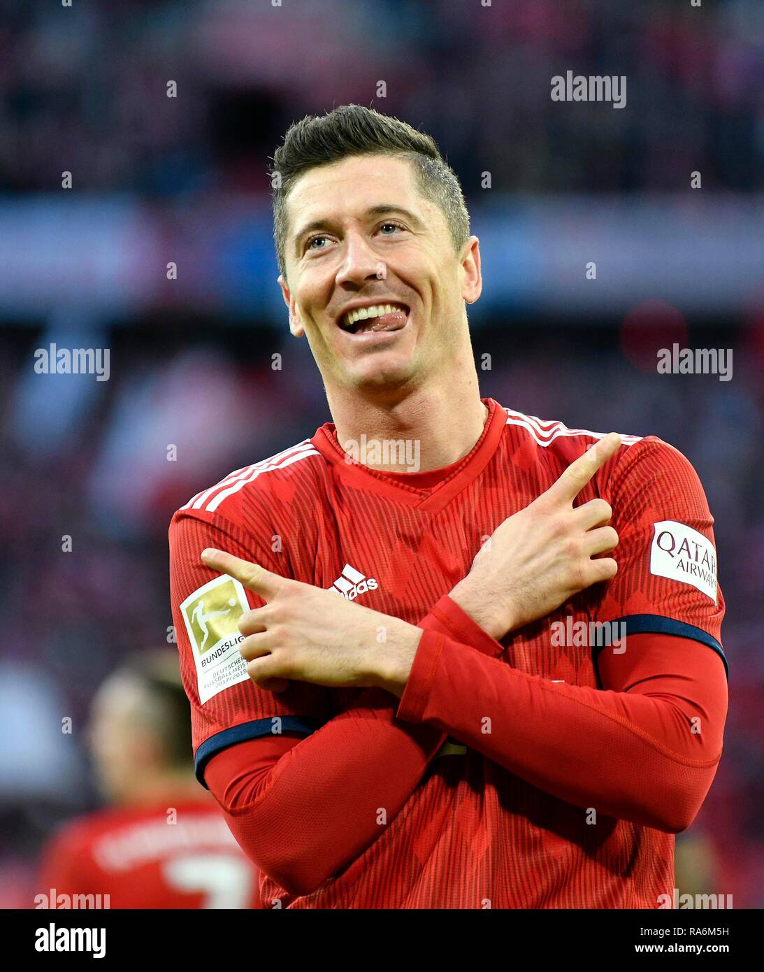 Typical goal celebration with crossed arms and outstretched tongue, Robert Lewandowski, FC Bayern Munich FCB, Allianz Arena Stock Photo