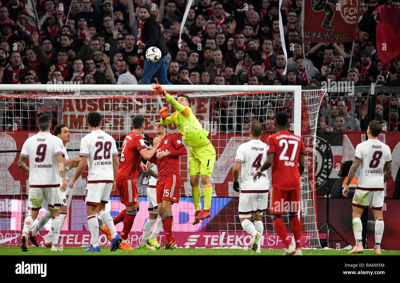 Goalkeeper Fabian Bredlow 1st FC Nuremberg FCN fists ball after corner ball ahead of Thomas Müller FC Bayern Munich Stock Photo