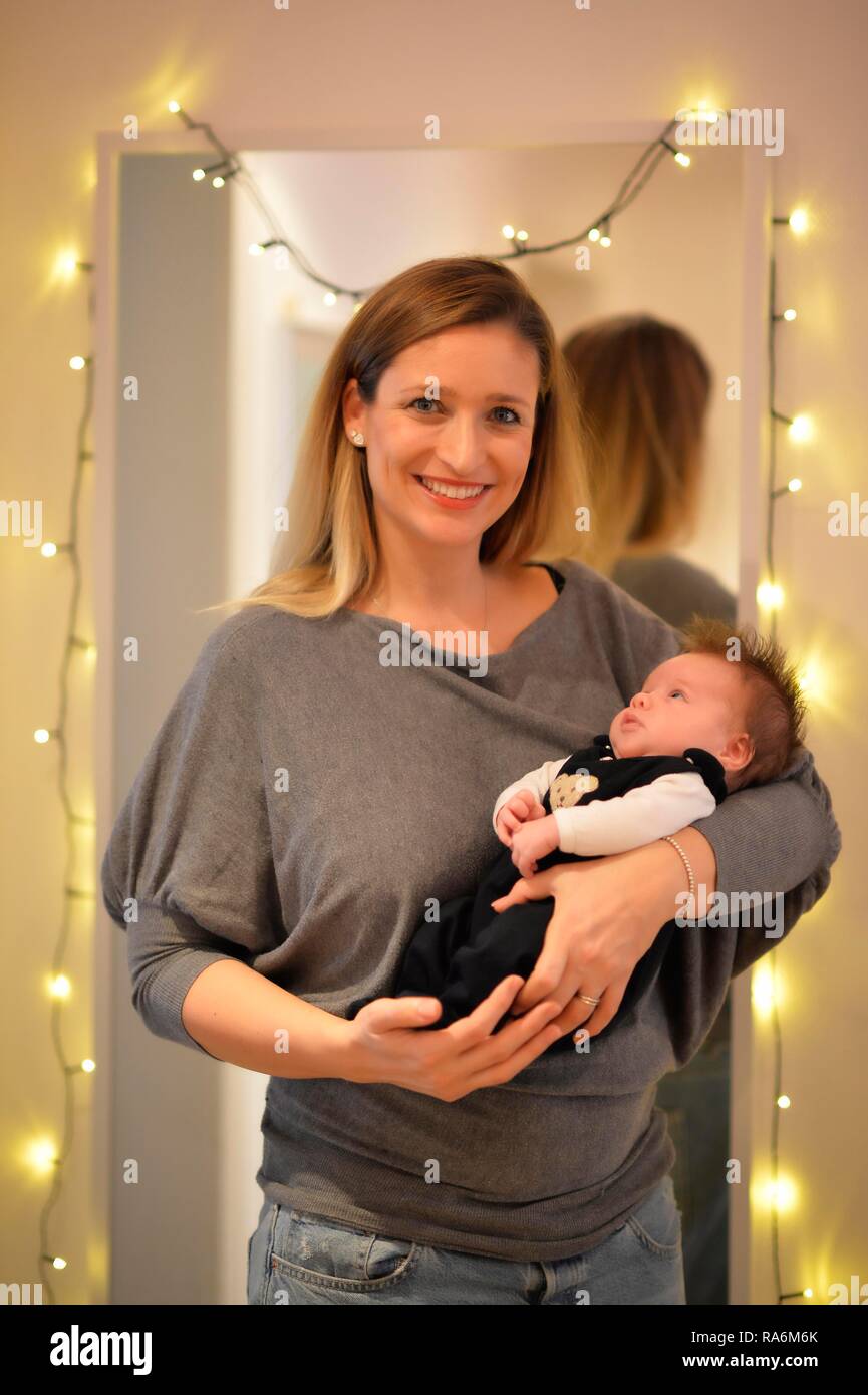 Proud mother keeps infant, 6 weeks, Germany Stock Photo