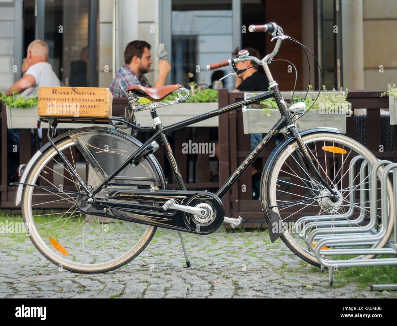 Classic city bike and revellers. Warsaw, Poland Stock Photo