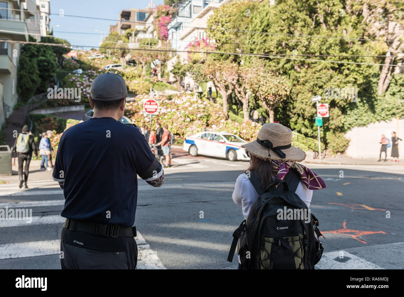 Tourists take pictures at the entrance of the most winding part of
