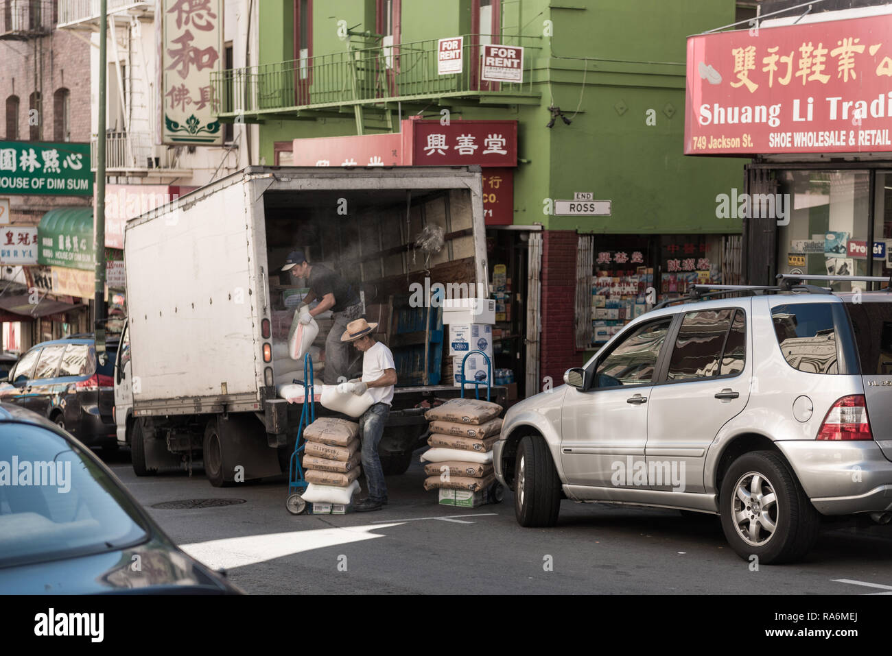 Workers unload goods from a truck in Chinatown in San Francisco, California, USA Stock Photo