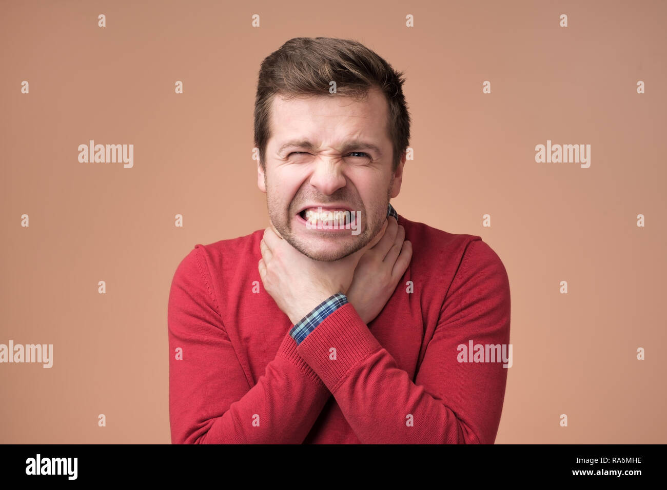 Young man having asthma attack or choking can not breath suffering from respiration problems Stock Photo
