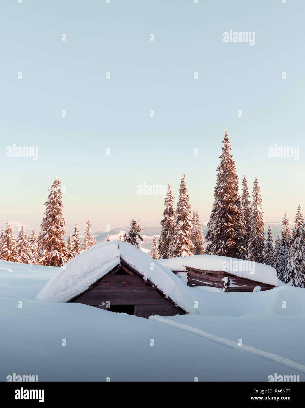 Fantastic winter landscape with wooden house in snowy mountains ...