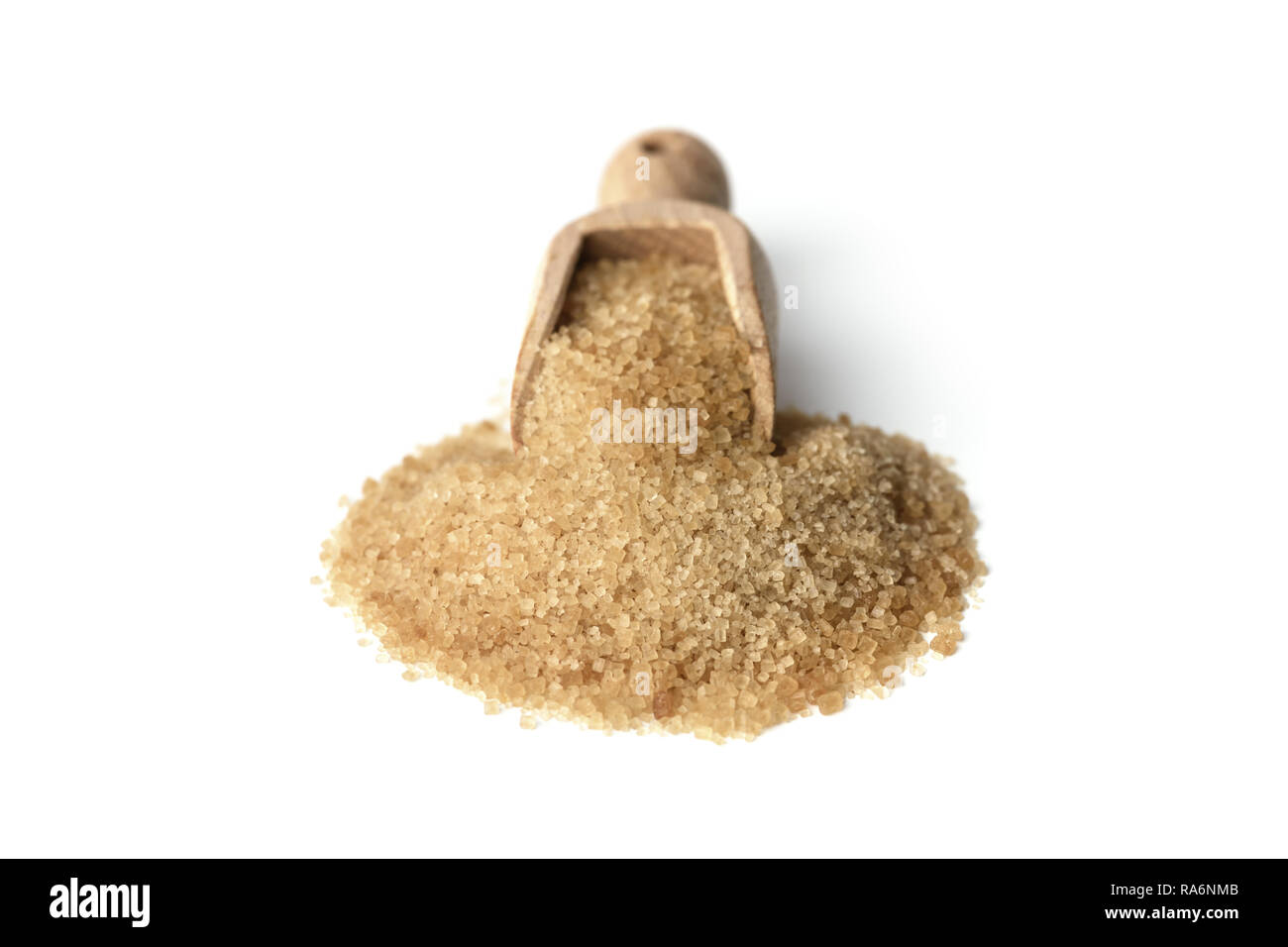 Brown cane sugar crystals in wooden scoop isolated on white background Stock Photo