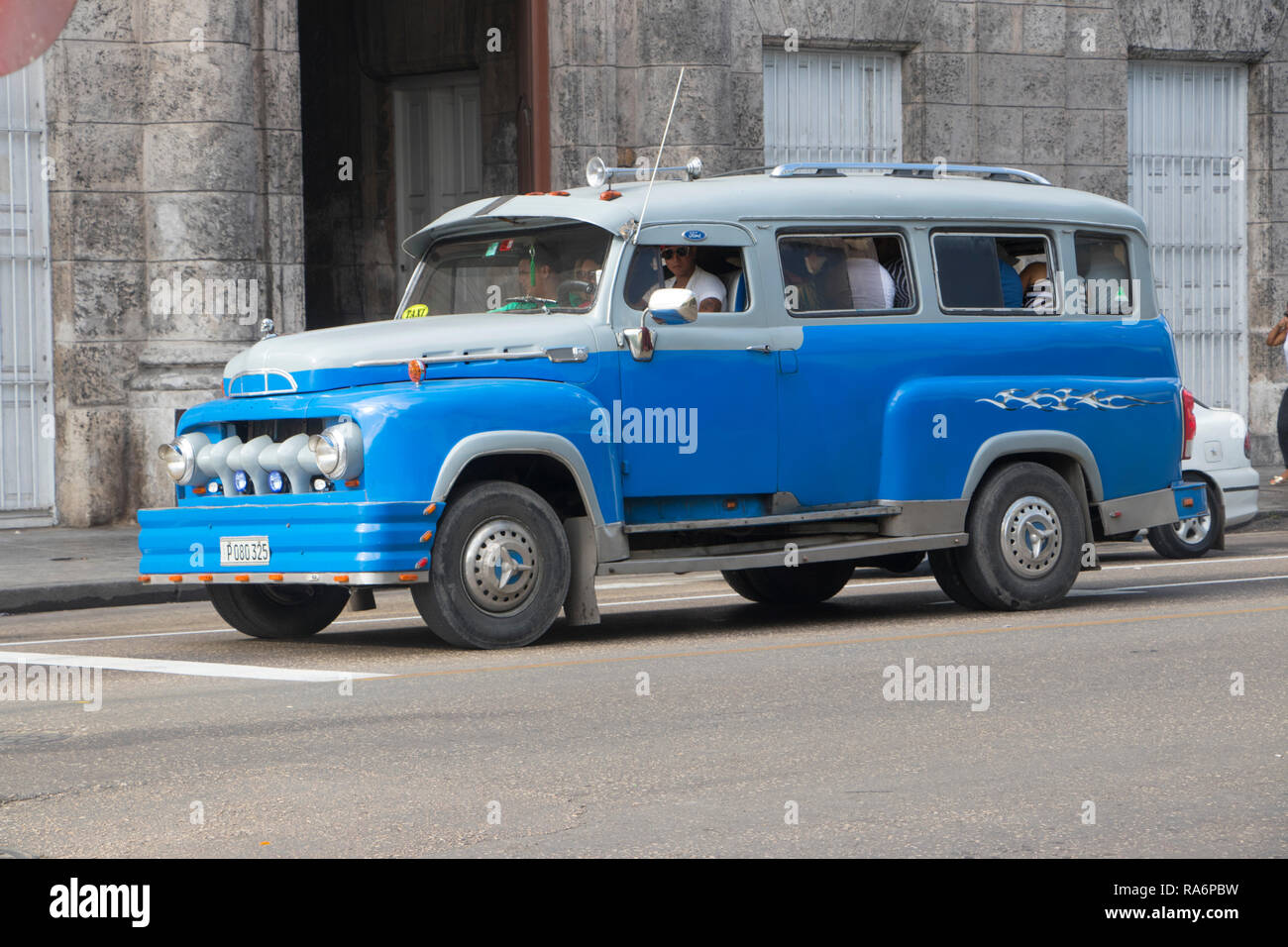 classic vintage American bus driving in Havana, Cuba, Caribbean Stock Photo