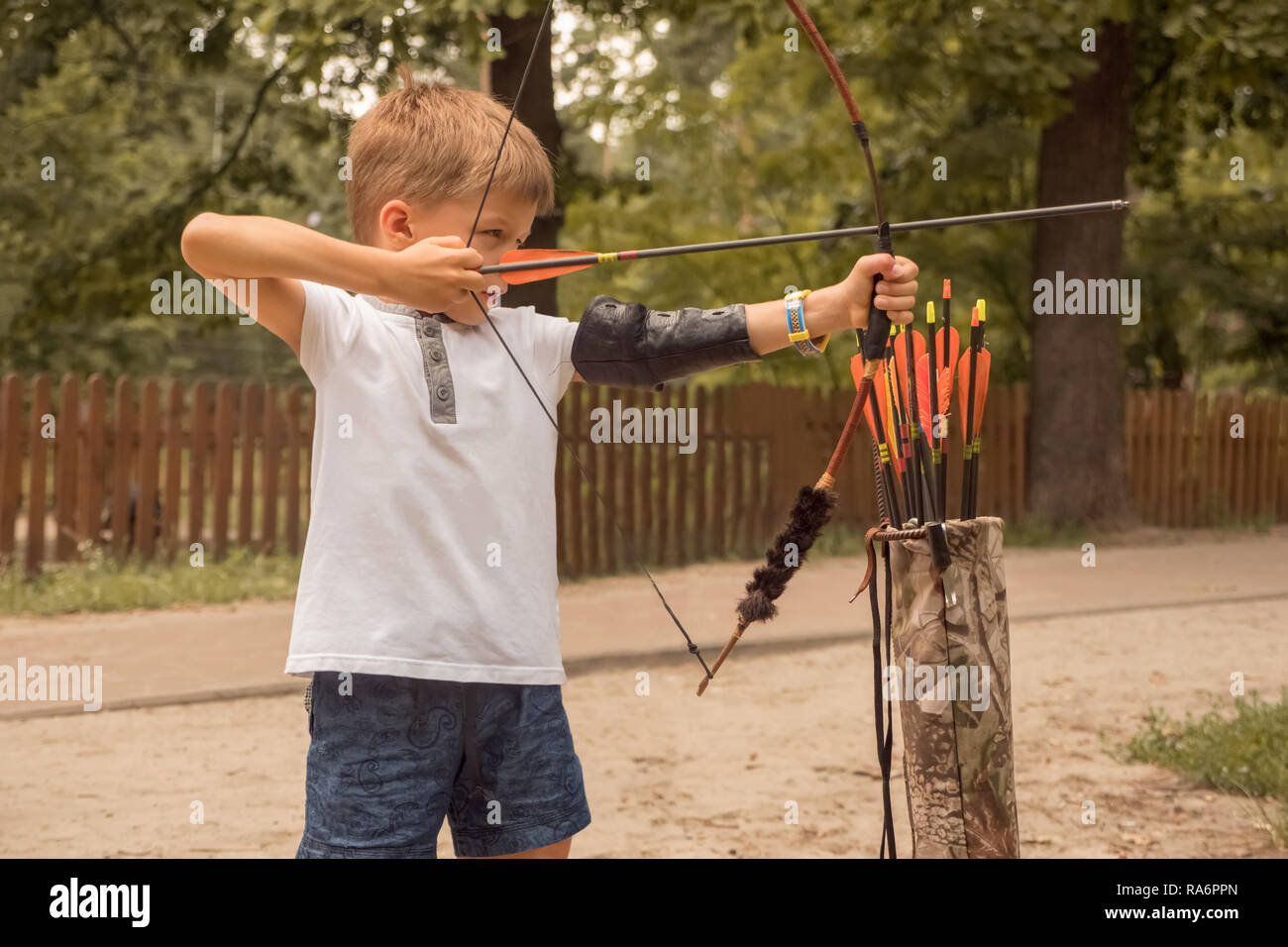 Boy with a bow and arrow. Children and sports Stock Photo Alamy