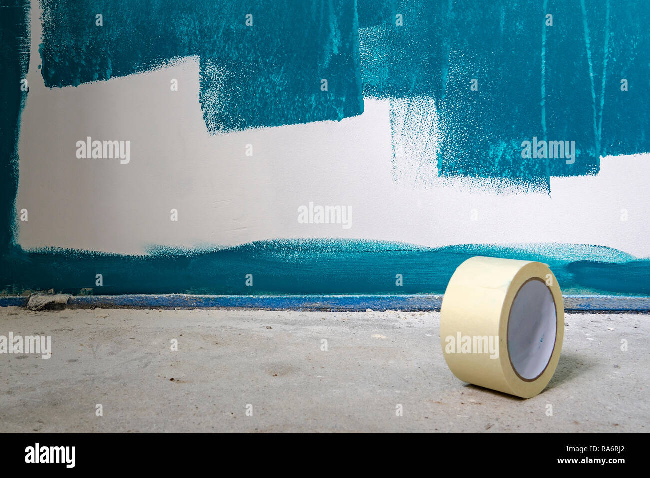 Painting works on a wall. With a roll of duct tape in the foreground