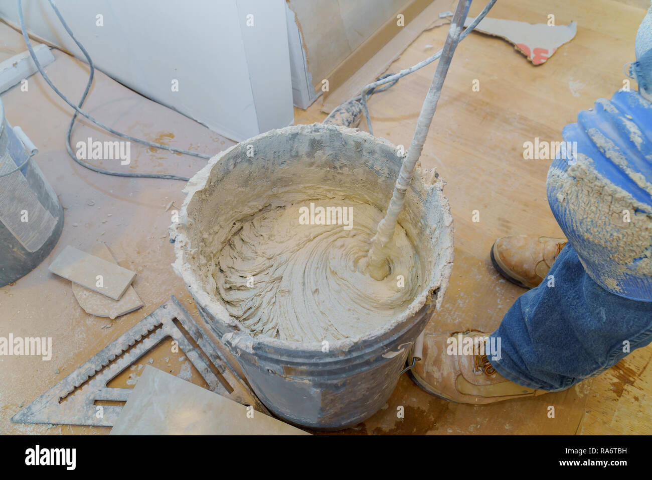 Mixing Tile adhesive cement with a power drill Stock Photo Alamy