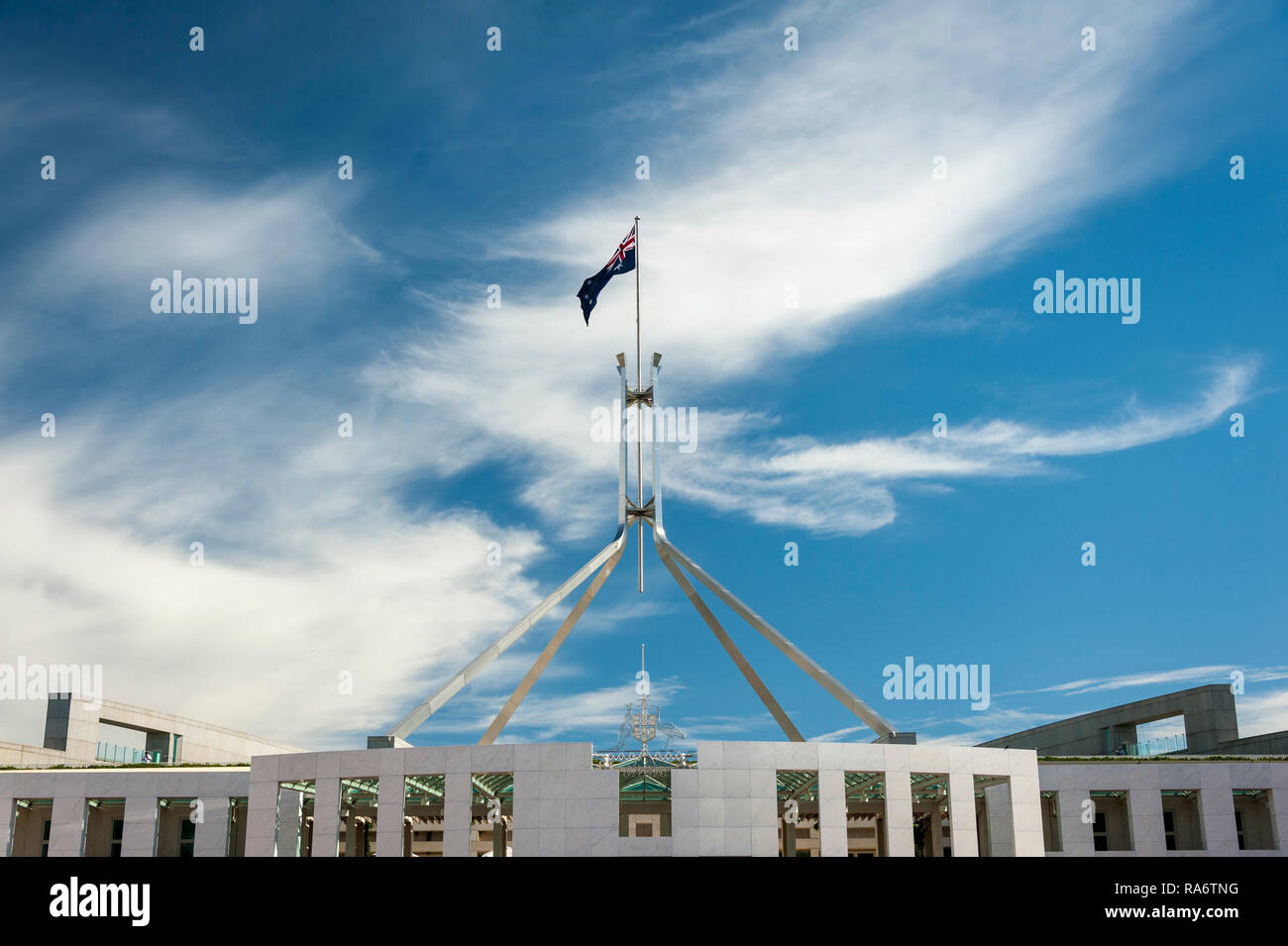 The Australian flag atop the mast of the Parliament building, Canberra