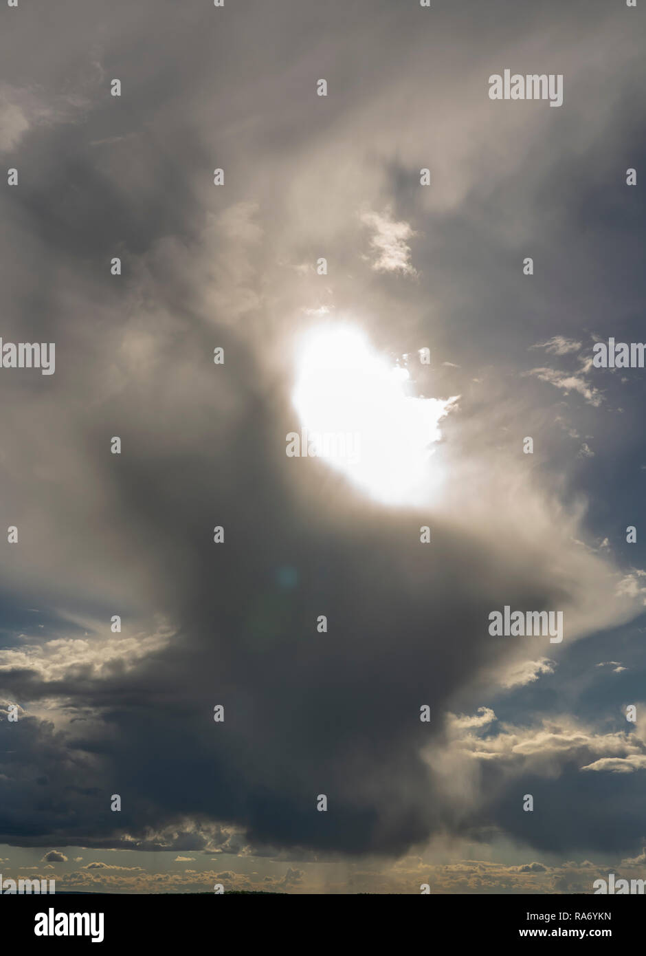 the sun making its way through the clouds Stock Photo - Alamy