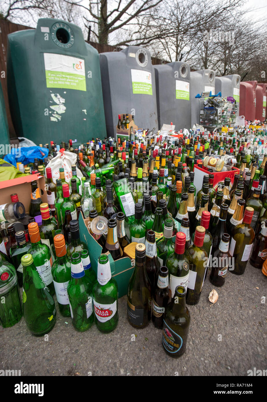 Bottles in front of a bottle bank at a recycling centre at a