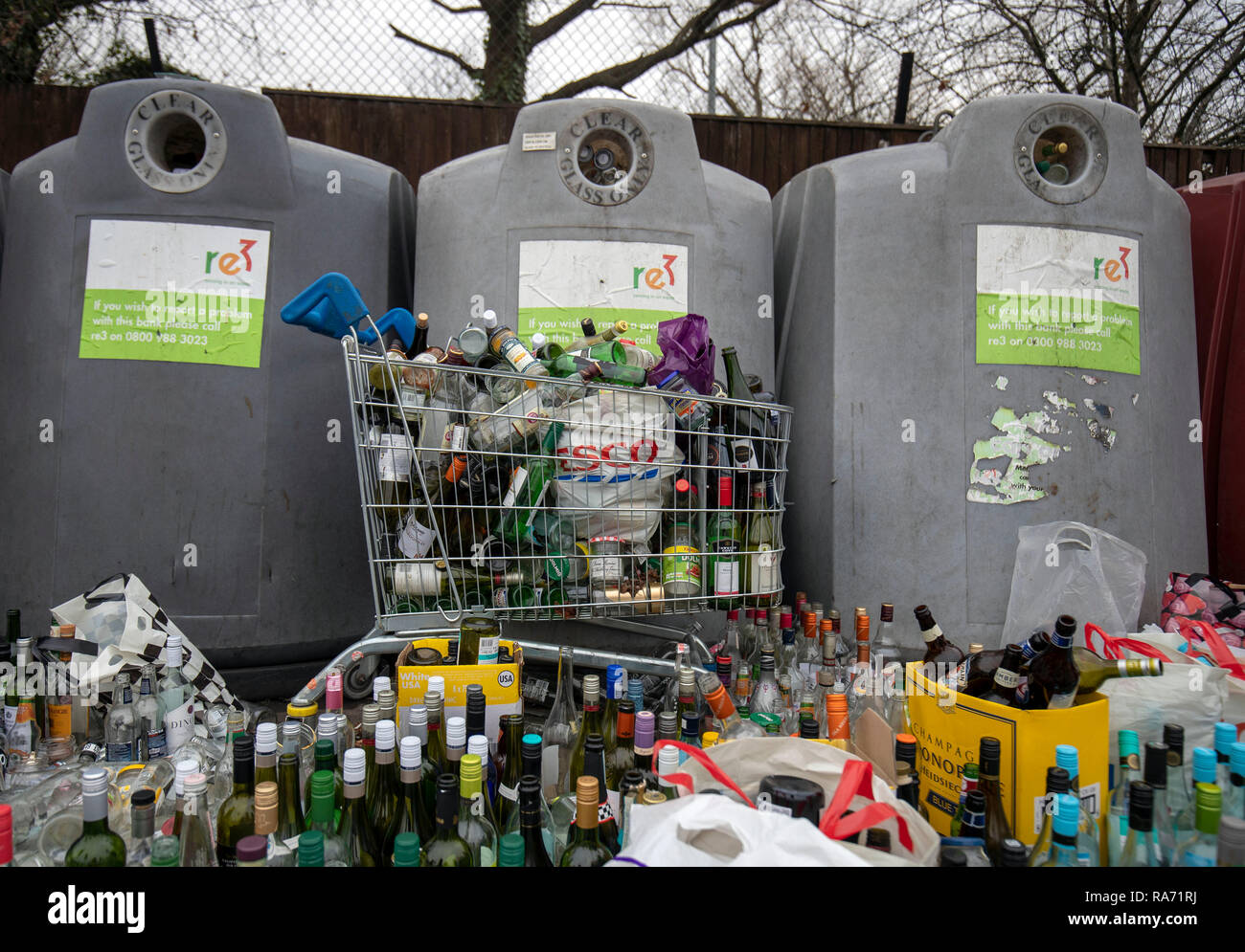 Bottles in front of a bottle bank at a recycling centre at a