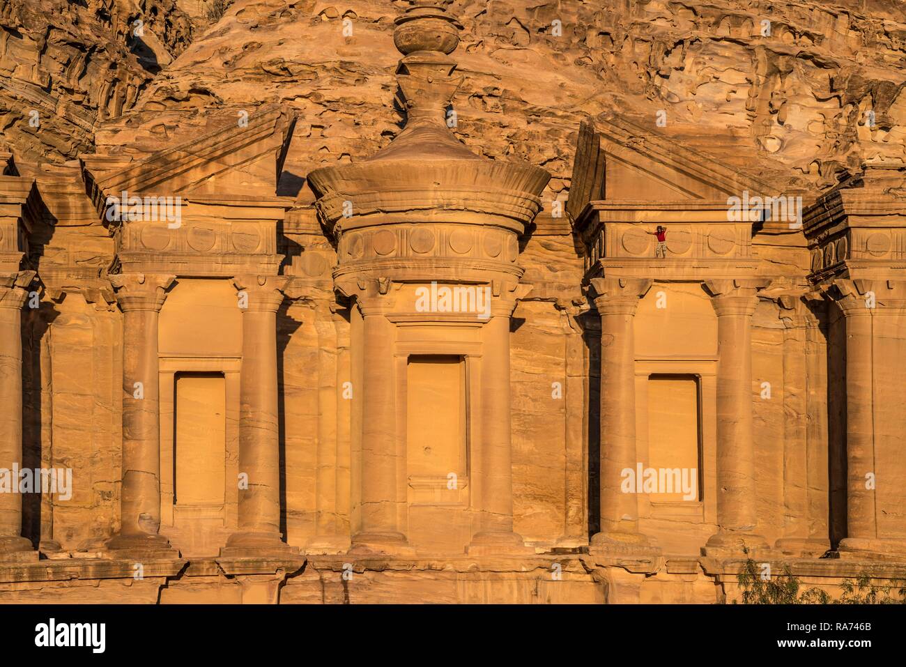 Visitor climbs on the rock temple Monastery Ad Deir, Petra, Jordan Stock Photo