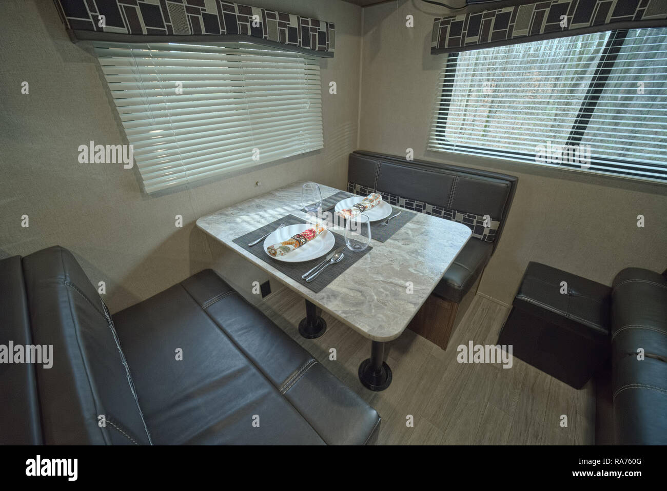 Set table inside RV travel trailer. Dining table in RV camper Stock