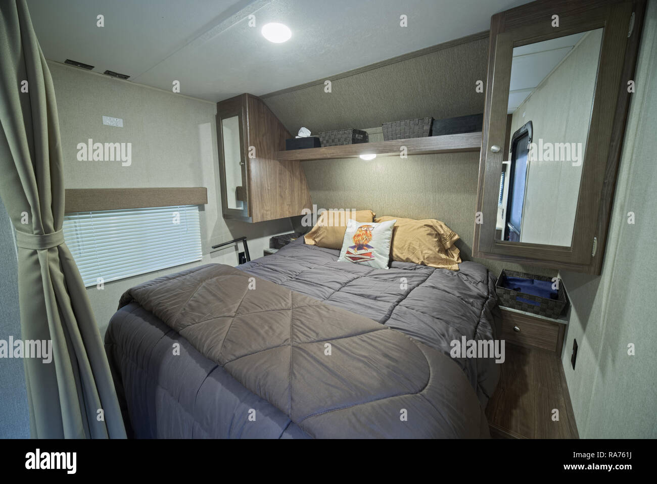Bed area inside RV travel trailer. Camper bed. Stock Photo