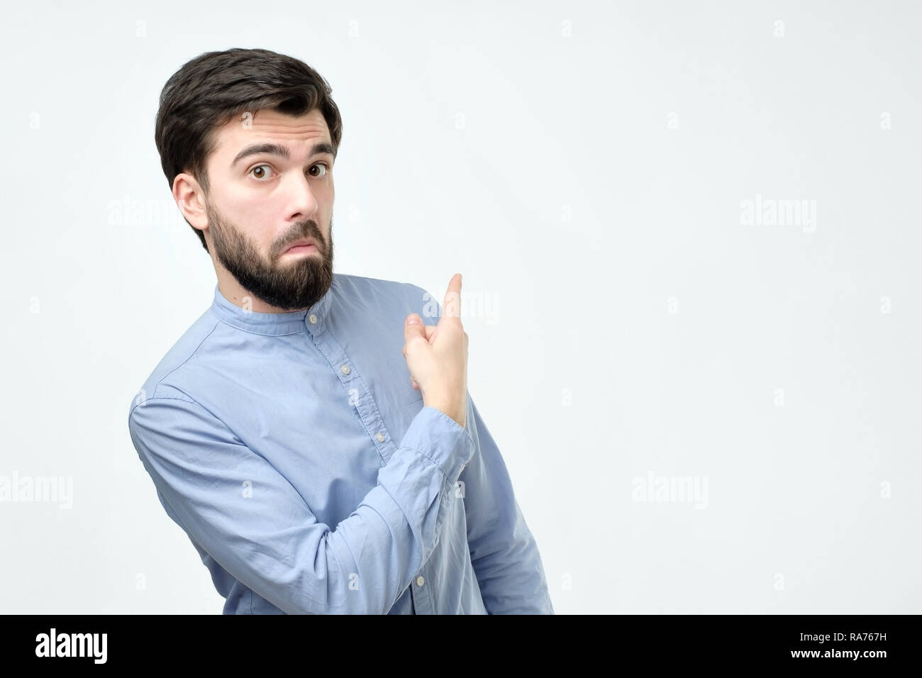 Stylish handsome young hispanic man pointing aside. Stock Photo