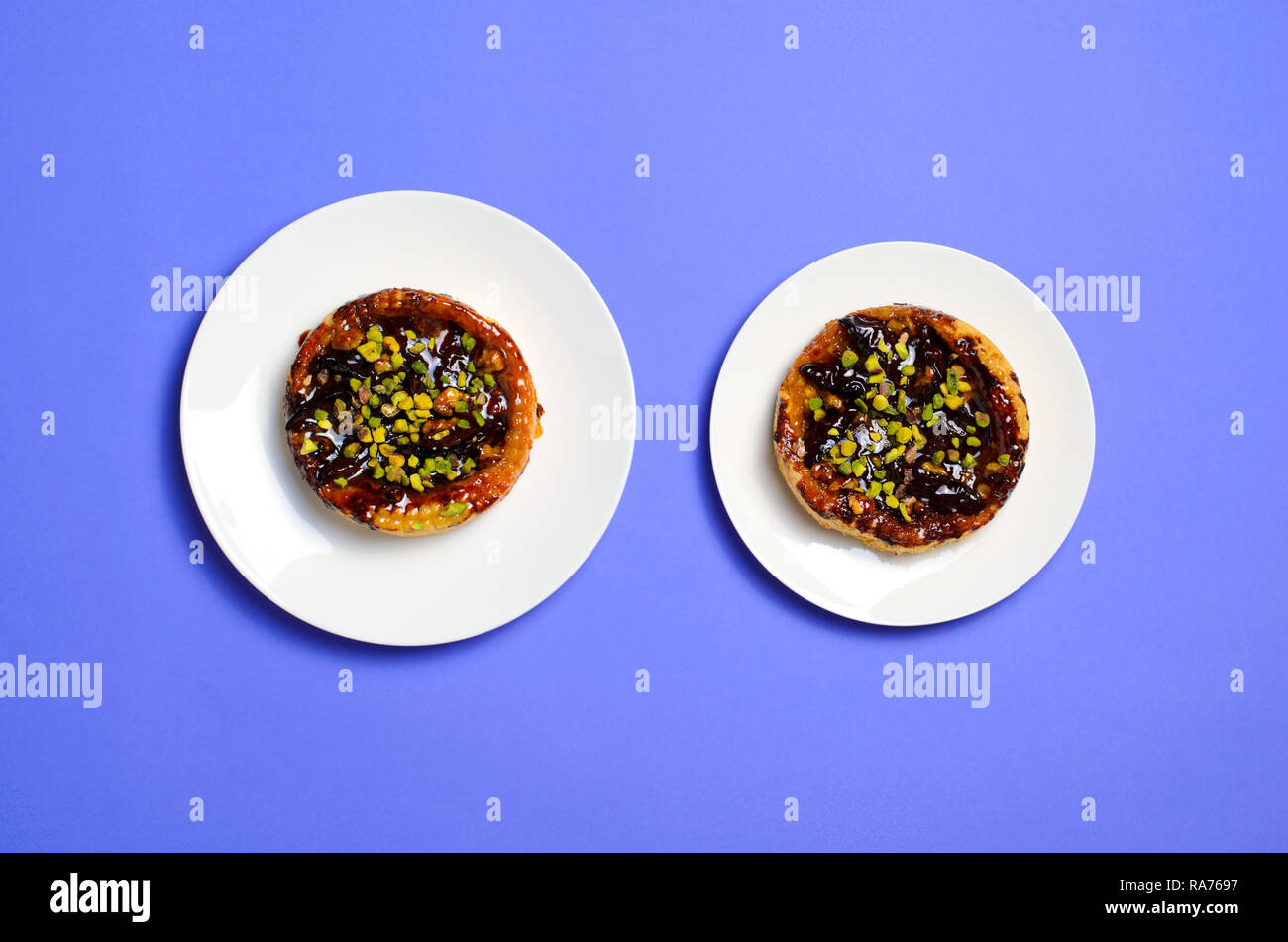 Size Matters, Diet Concept, Plum and Pistachio Dessert on Plates, Top View Stock Photo