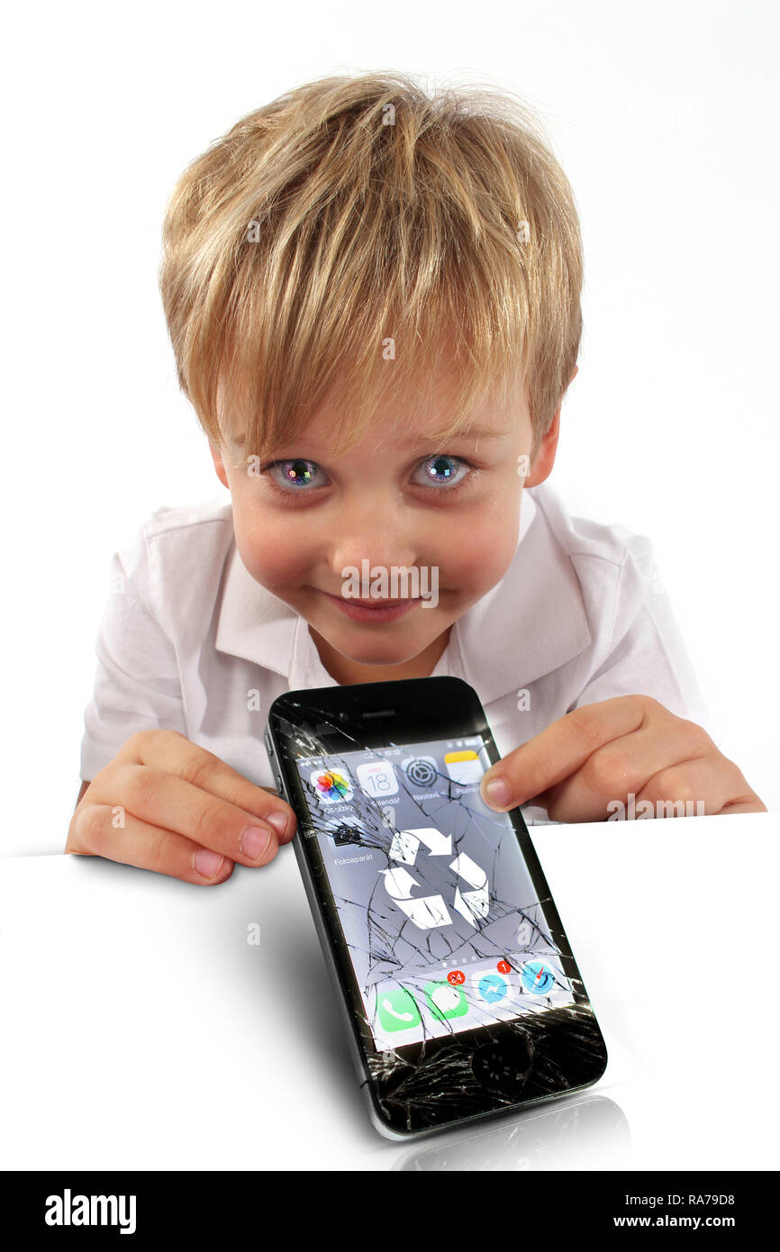 Boy holding, showing display of smartphone, cellphone demonstrating internet safety with symbols caution, forbidden, check mark, recycle Stock Photo