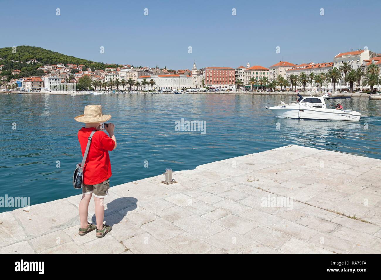 Boy taking pictures, Promenade, Split, Dalmatia, Croatia Stock Photo