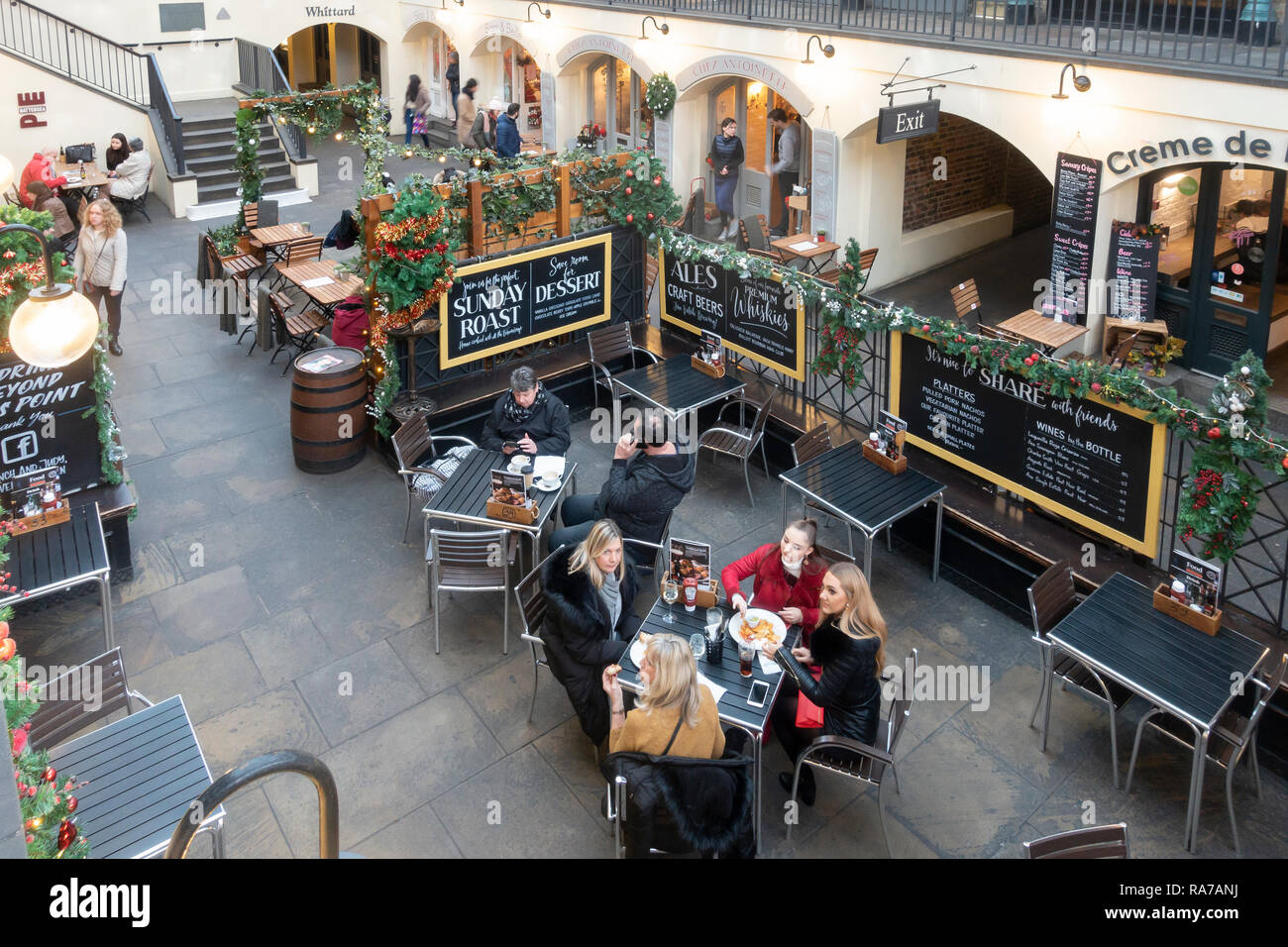 Elevated view of people eating and browsing in the piazza of the Covent Garden Market Building in central London, England, UK. Stock Photo