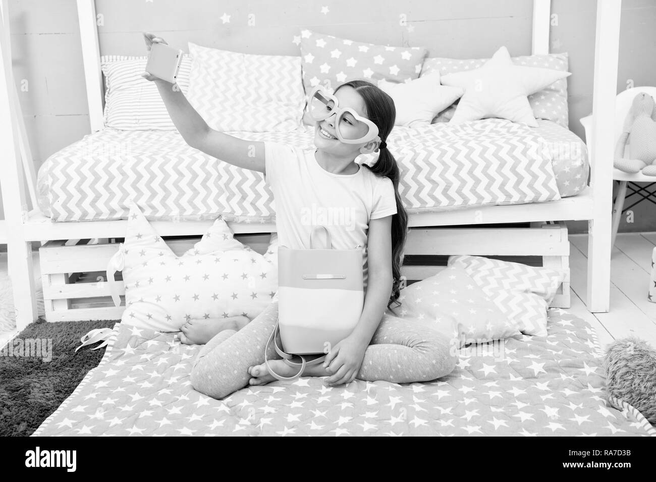 Subscribe her vlog. Vlogger streaming video. Girl child sit on bed in