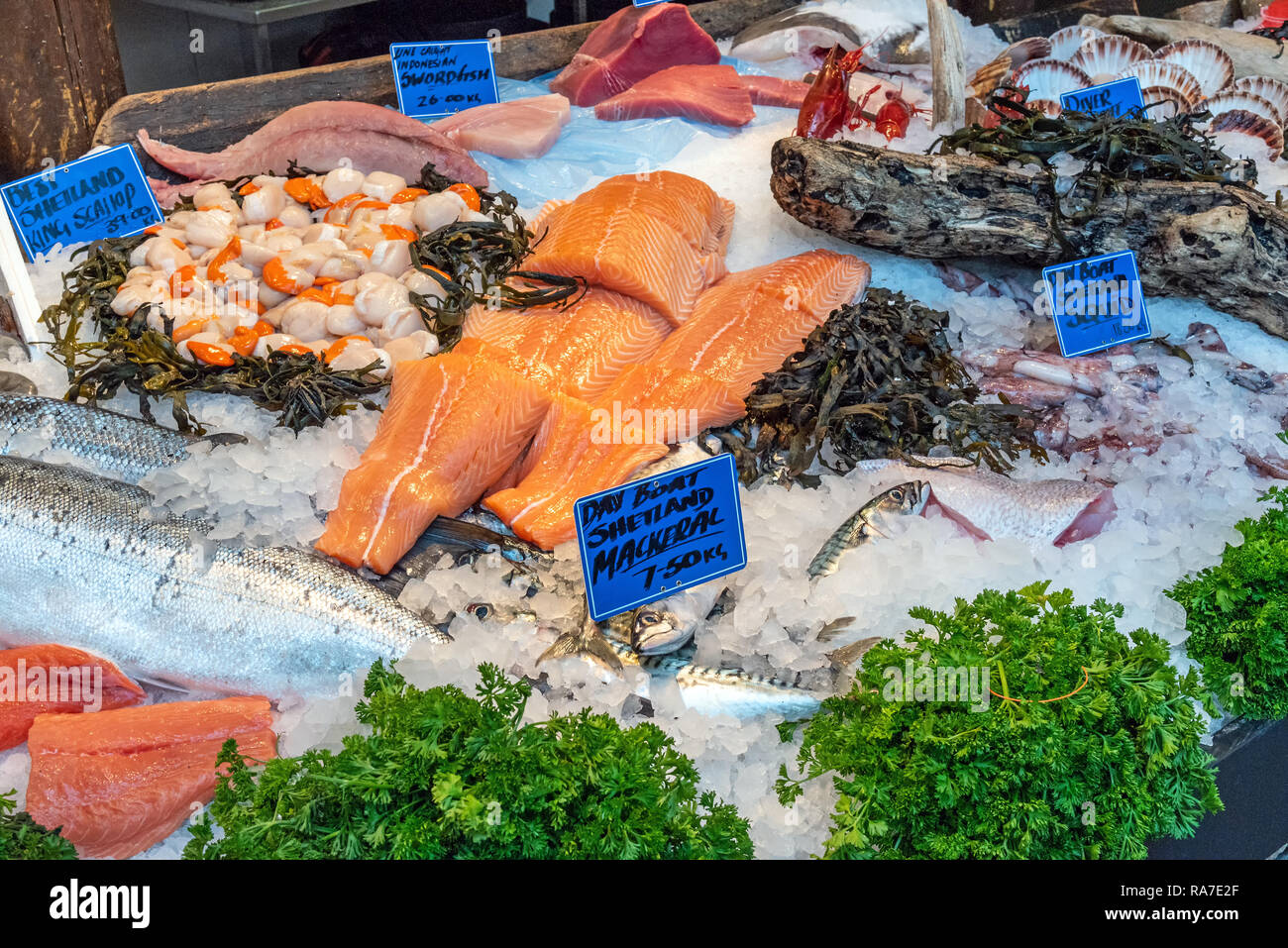 Salmon fillet and other fish and seafood for sale at a market in London, UK Stock Photo