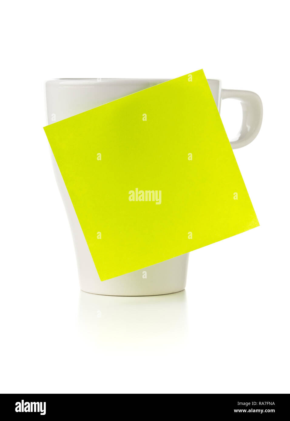 Yellow empty sticky note on white coffee or tea cup over white ...