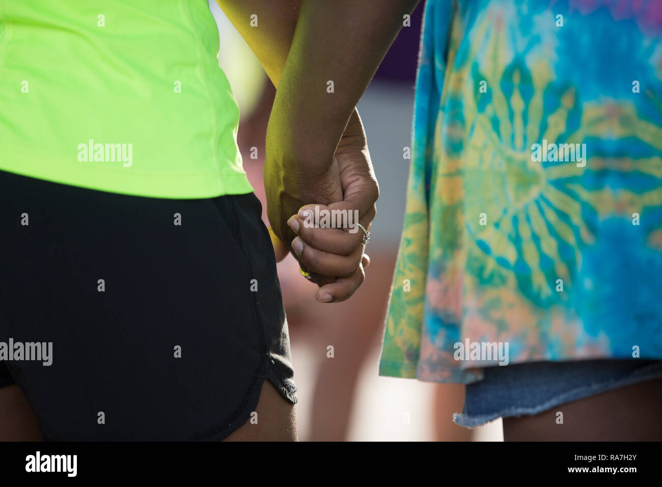 A closeup of two African American women standing next to each other holding hands Stock Photo