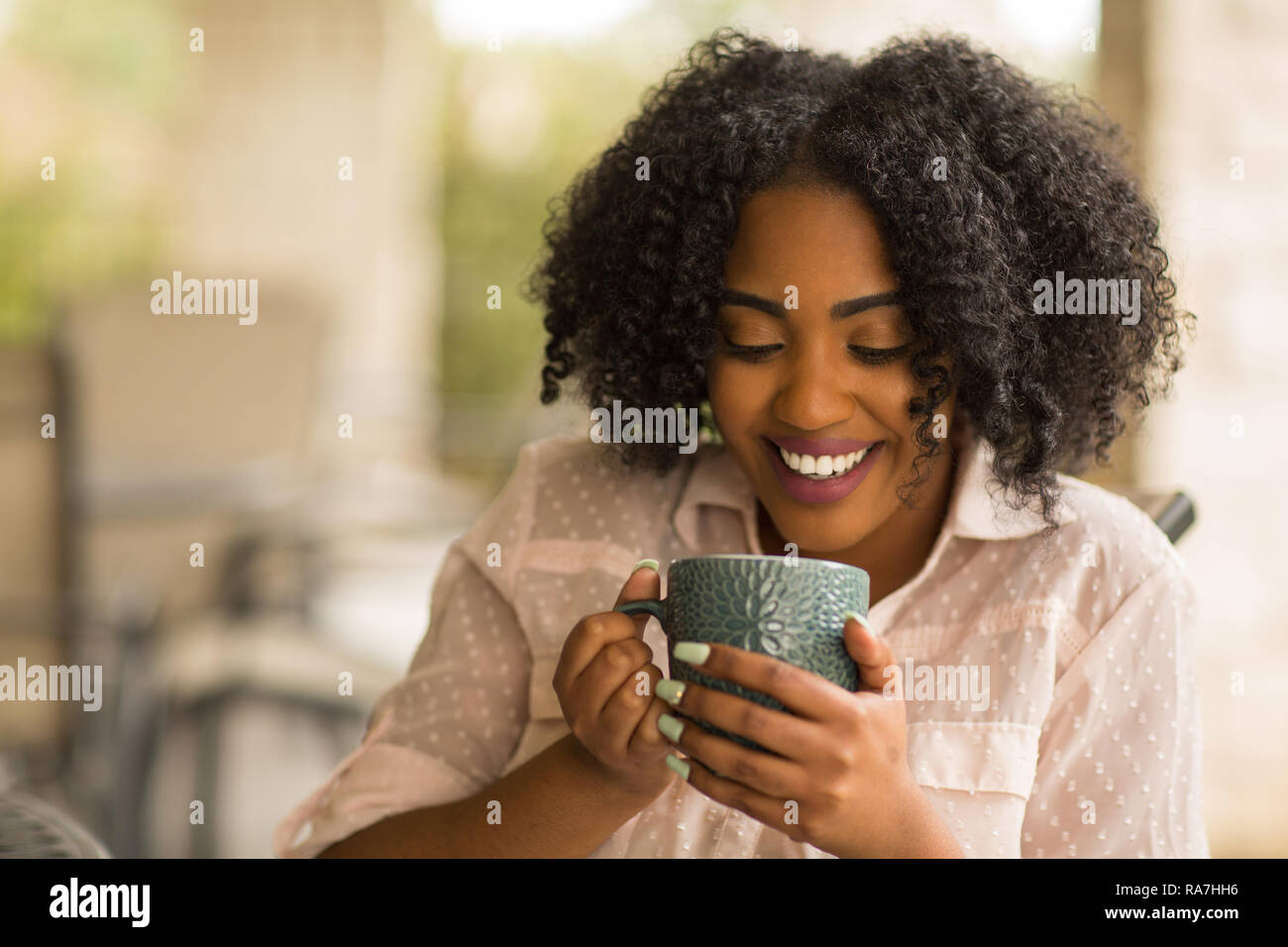 Portrait of an African American woman drinking coffee Stock Photo - Alamy