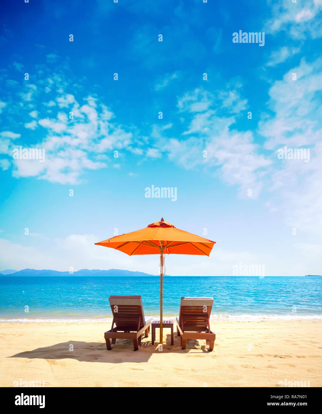 Two lounge chairs with sun umbrella on a beach Stock Photo Alamy