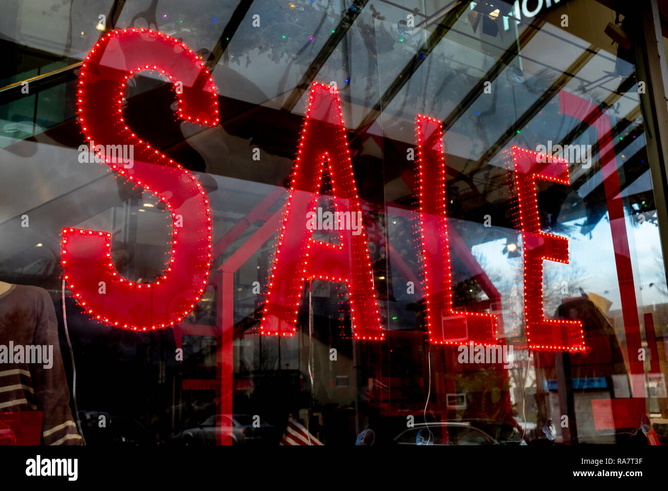 Illuminated sale sign in shop window UK Stock Photo
