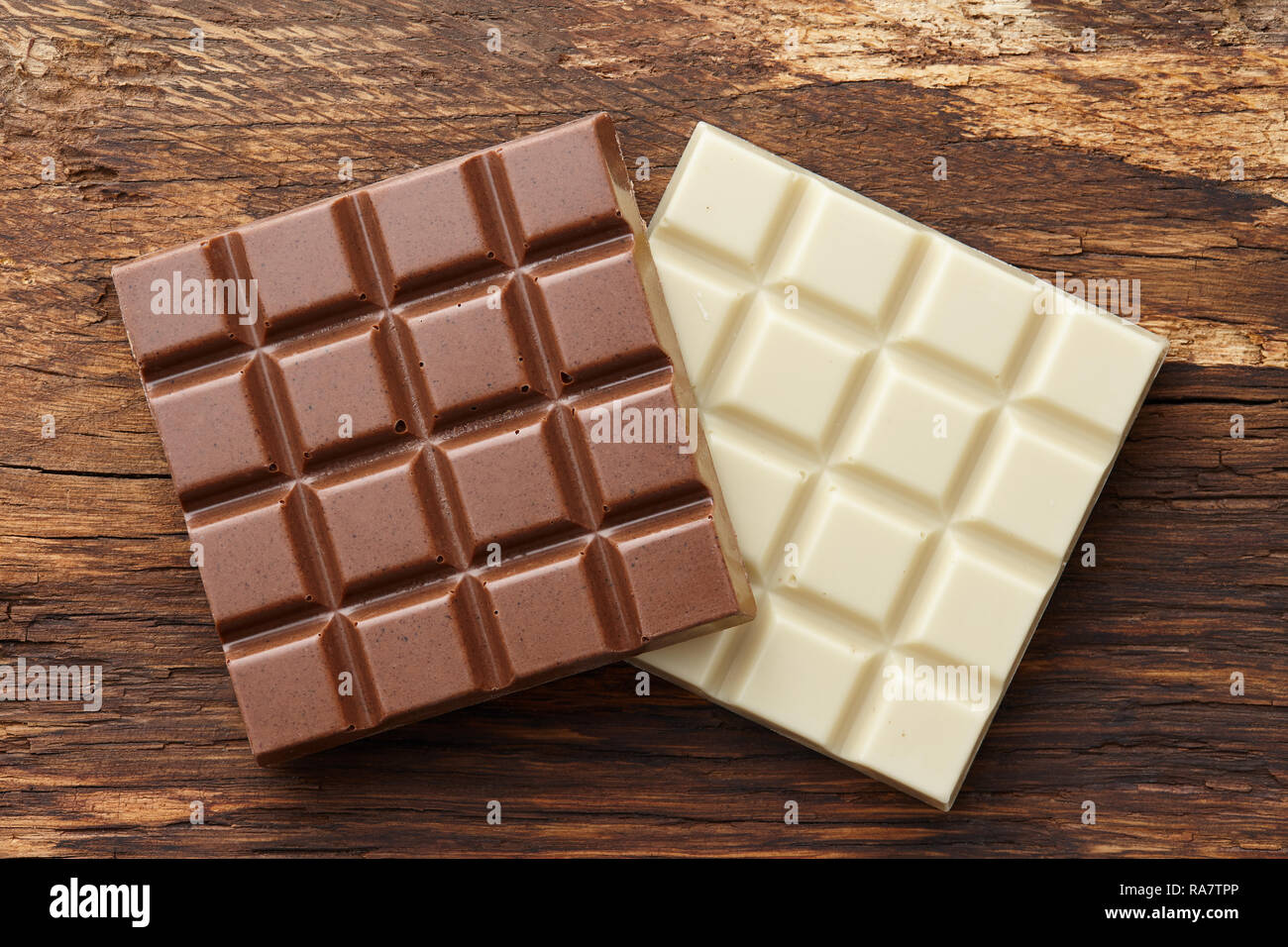 Milk and white chocolate bars on wooden background Stock Photo