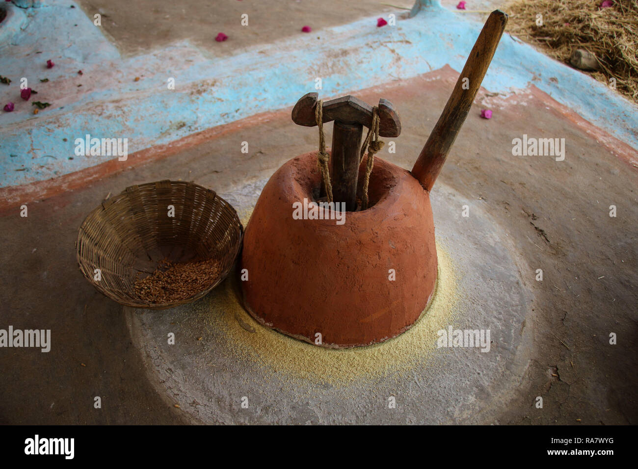 The traditional way of grinding grain by hand in the village around Khajuraho, India Stock Photo