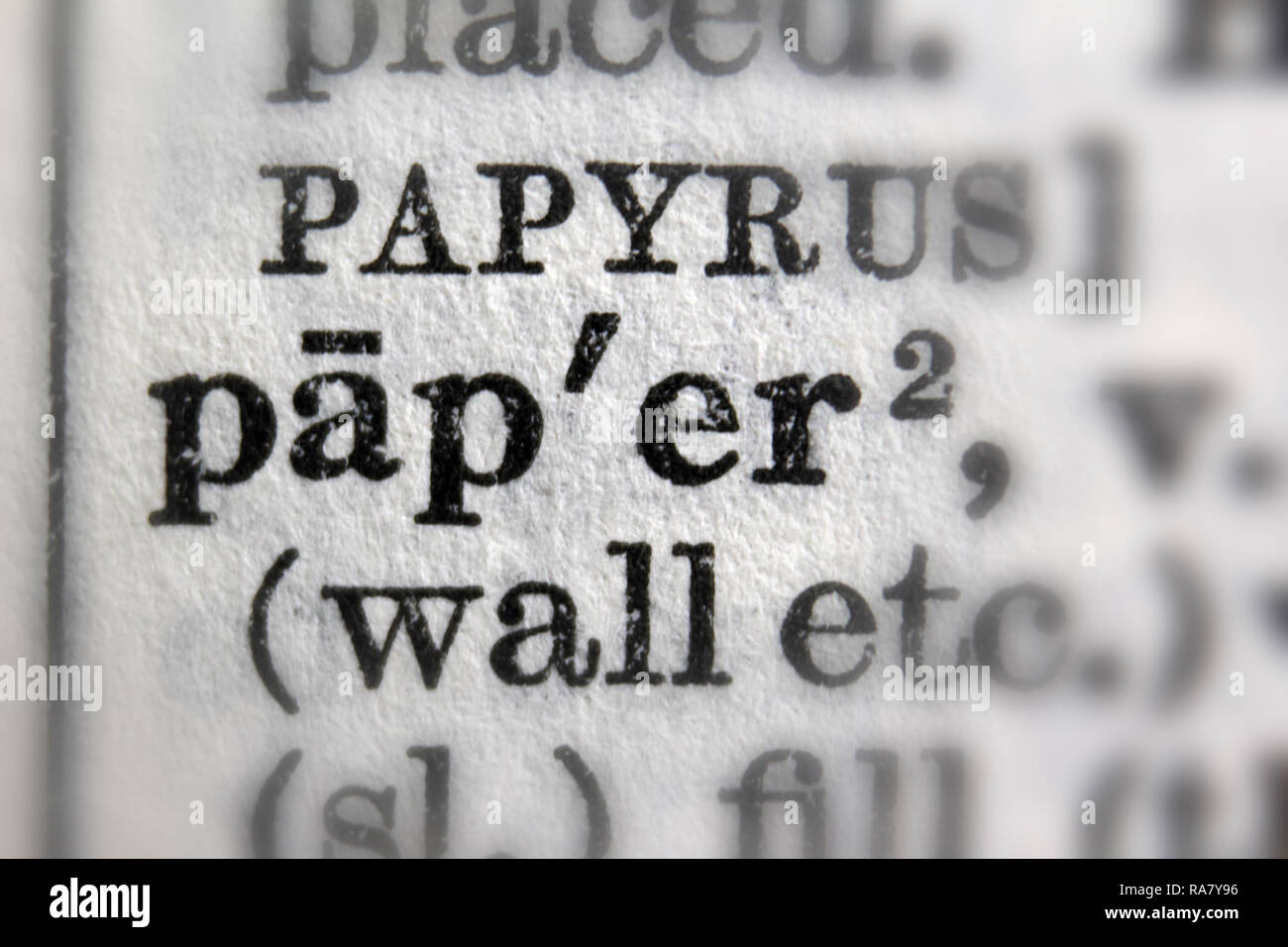 Paper and papyrus words bold on Oxford English Dictionary, close up Stock Photo