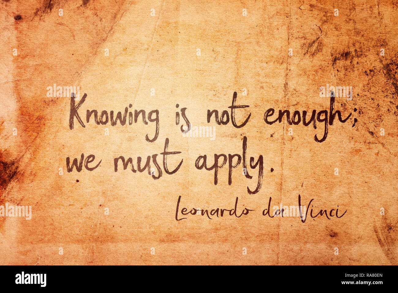Knowing is not enough; we must apply - ancient Italian artist Leonardo da Vinci quote printed on vintage grunge paper Stock Photo