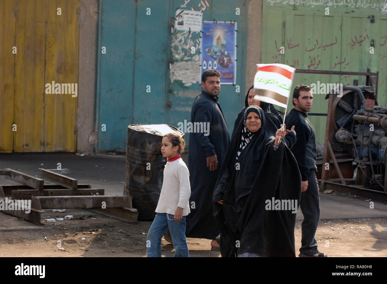 On the streets of Baghdad, Iraq happy citizen blew there horns, cheered, and proudly waved the national flag as they walked through the streets. Stock Photo