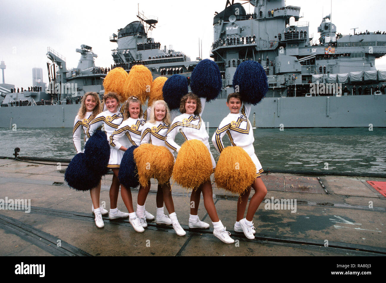 Cheerleaders pose as the battleship USS NEW JERSEY (BB 62) passes in review during the Australian bicentennial celebration. Stock Photo